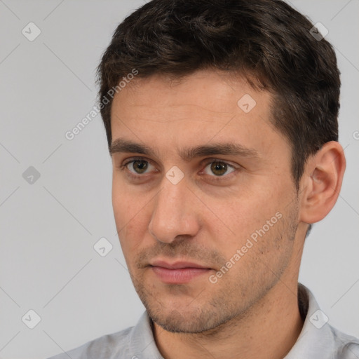 Joyful white adult male with short  brown hair and brown eyes