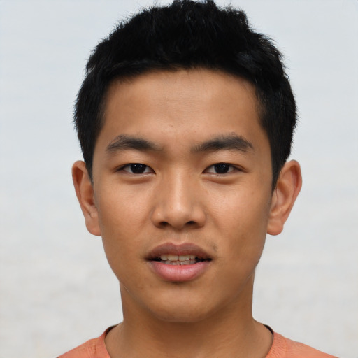 Joyful asian young-adult male with short  black hair and brown eyes