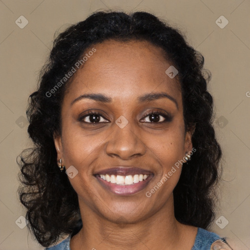 Joyful black young-adult female with long  brown hair and brown eyes