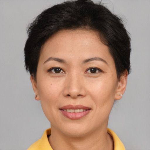 Joyful asian adult female with short  brown hair and brown eyes