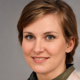 Joyful white adult female with medium  brown hair and brown eyes