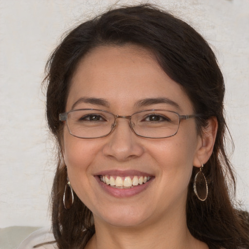 Joyful white adult female with long  brown hair and brown eyes