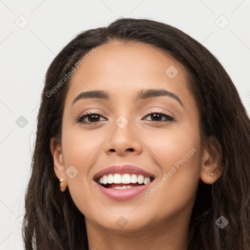 Joyful latino young-adult female with long  brown hair and brown eyes