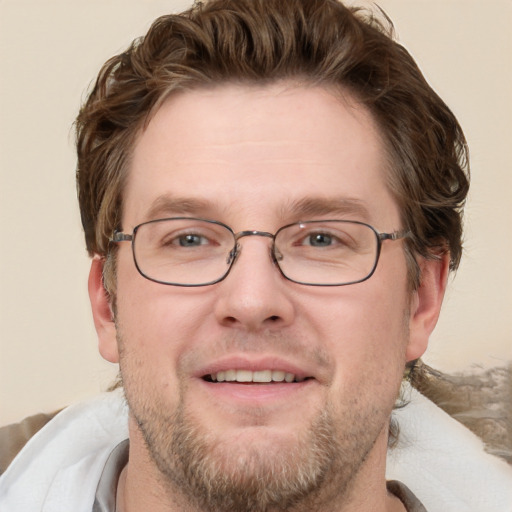 Joyful white adult male with short  brown hair and grey eyes