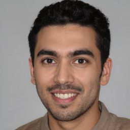 Joyful white young-adult male with short  black hair and brown eyes