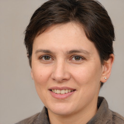 Joyful white adult female with medium  brown hair and brown eyes