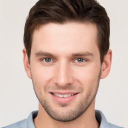 Joyful white young-adult male with short  brown hair and brown eyes