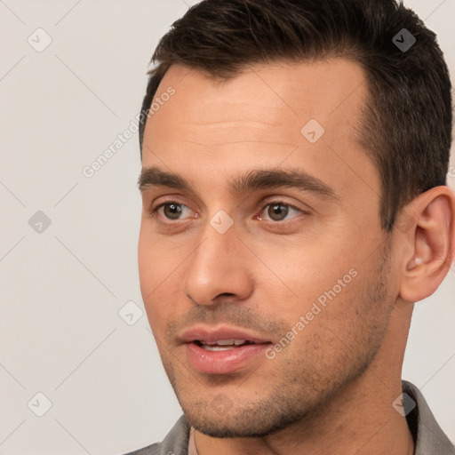 Joyful white young-adult male with short  brown hair and brown eyes