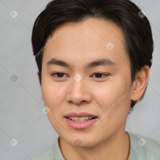 Joyful asian young-adult male with short  brown hair and brown eyes