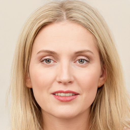 Joyful white young-adult female with long  brown hair and blue eyes