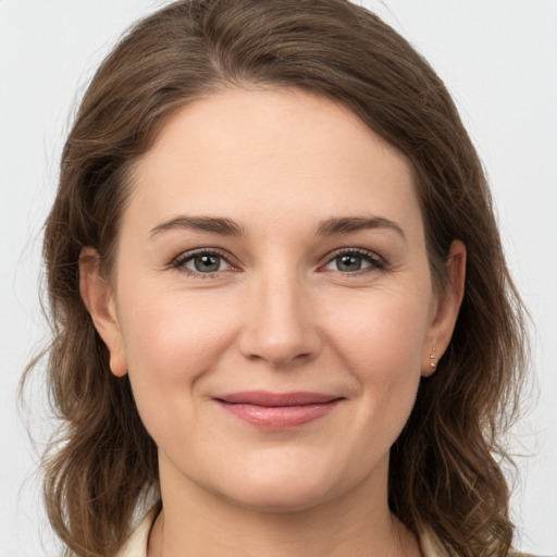 Joyful white young-adult female with medium  brown hair and grey eyes