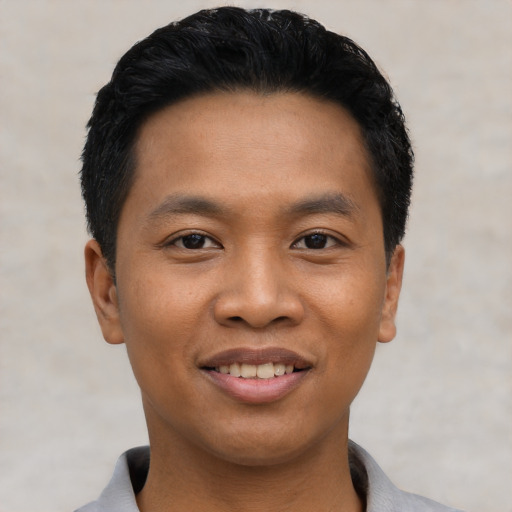 Joyful asian young-adult male with short  black hair and brown eyes