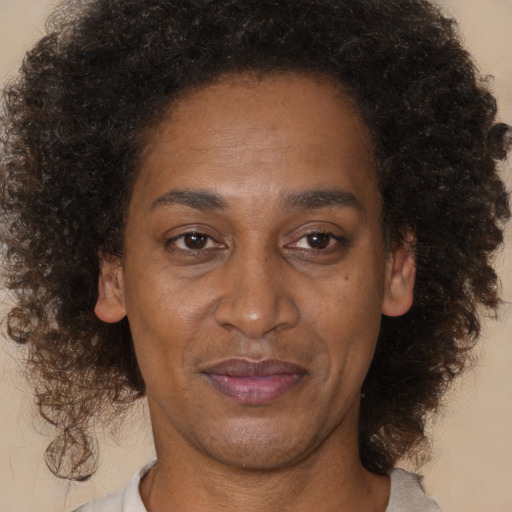 Joyful black adult female with short  brown hair and brown eyes