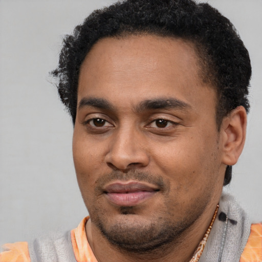 Joyful latino young-adult male with short  black hair and brown eyes