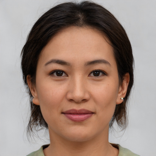 Joyful asian young-adult female with medium  brown hair and brown eyes
