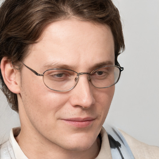 Joyful white adult male with short  brown hair and blue eyes