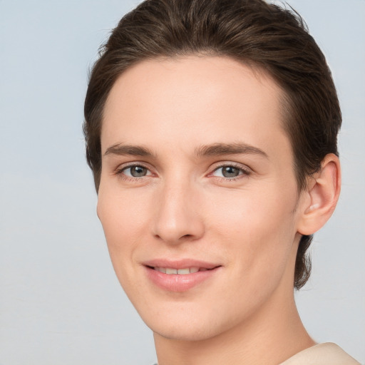 Joyful white young-adult female with short  brown hair and grey eyes