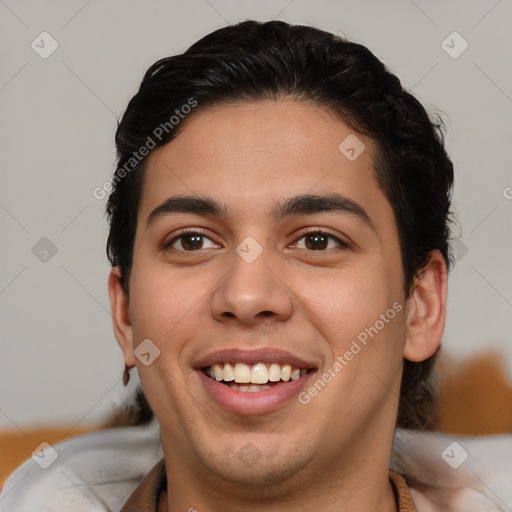 Joyful latino young-adult male with short  brown hair and brown eyes