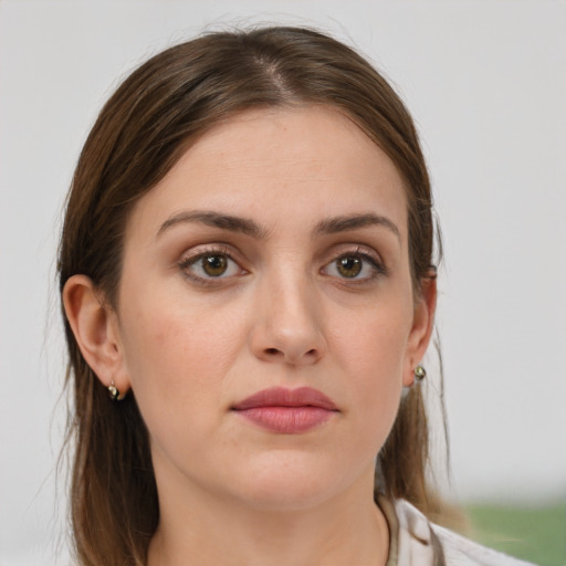 Joyful white young-adult female with medium  brown hair and grey eyes