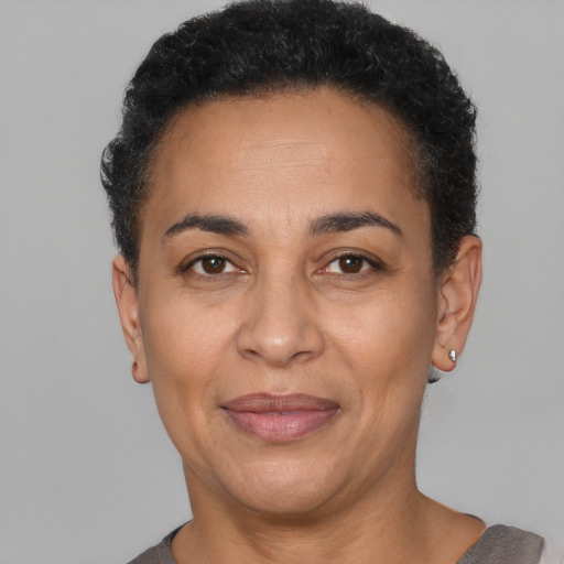 Joyful latino adult female with short  black hair and brown eyes
