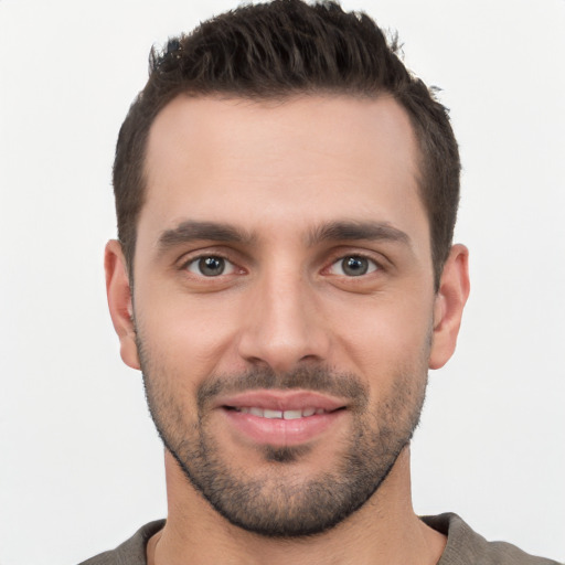 Joyful white young-adult male with short  black hair and brown eyes