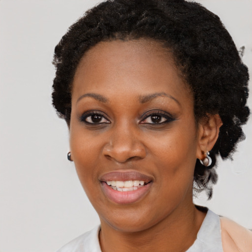 Joyful black adult female with short  black hair and brown eyes