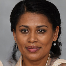 Joyful black adult female with medium  brown hair and brown eyes