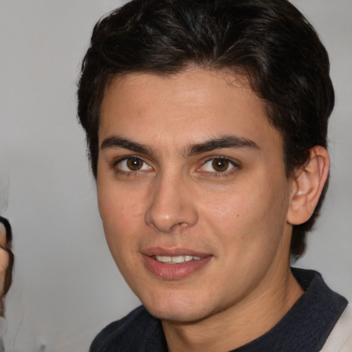 Joyful white young-adult male with medium  brown hair and brown eyes