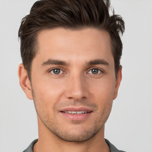 Joyful white young-adult male with short  brown hair and brown eyes