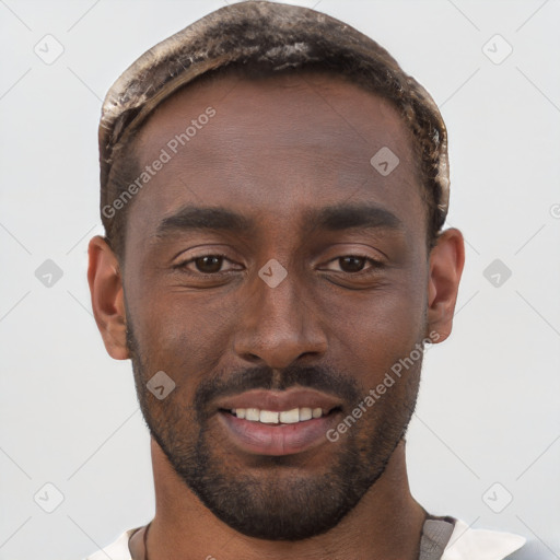 Joyful black young-adult male with short  brown hair and brown eyes