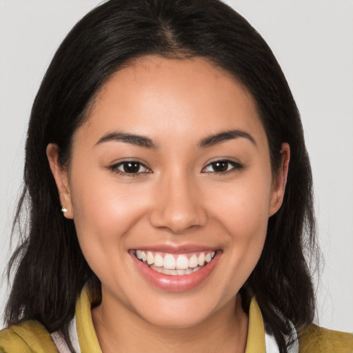 Joyful latino young-adult female with medium  brown hair and brown eyes