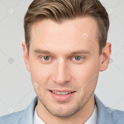 Joyful white young-adult male with short  brown hair and grey eyes