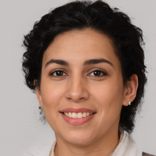 Joyful latino young-adult female with medium  brown hair and brown eyes
