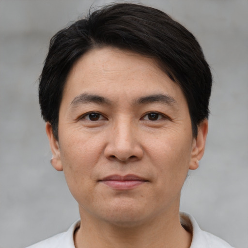 Joyful white adult male with short  black hair and brown eyes