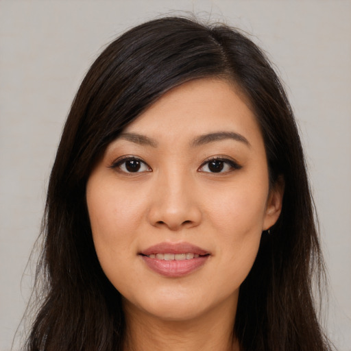 Joyful asian young-adult female with long  brown hair and brown eyes