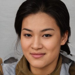 Joyful asian young-adult female with medium  brown hair and brown eyes