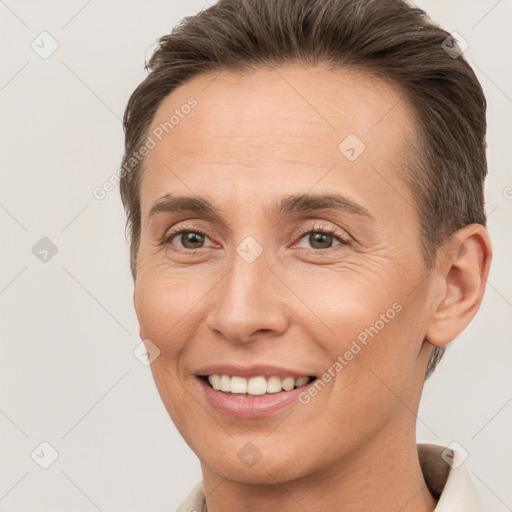 Joyful white adult female with short  brown hair and brown eyes