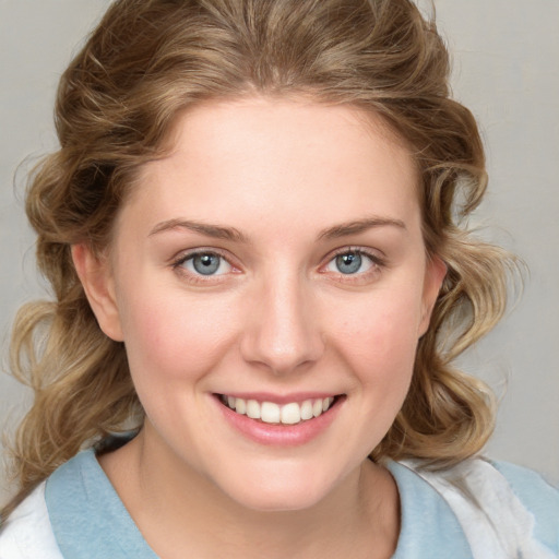 Joyful white young-adult female with medium  brown hair and blue eyes