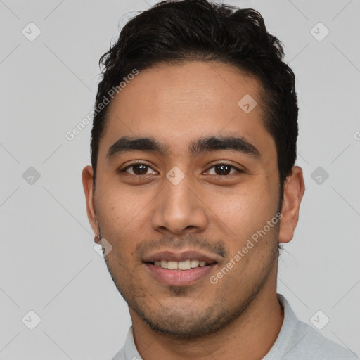 Joyful latino young-adult male with short  brown hair and brown eyes