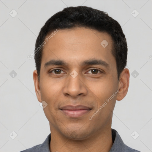 Joyful latino young-adult male with short  black hair and brown eyes