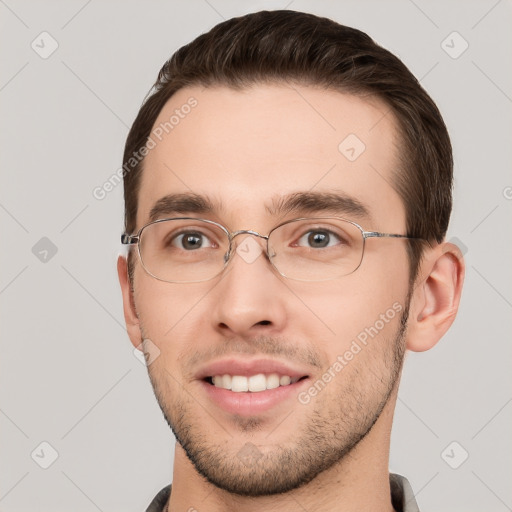 Joyful white young-adult male with short  brown hair and grey eyes