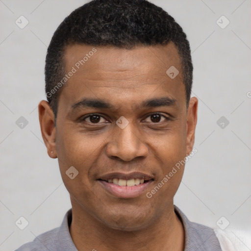 Joyful latino young-adult male with short  black hair and brown eyes