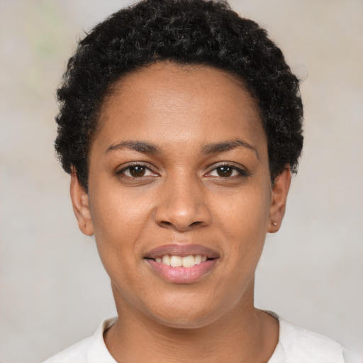 Joyful black young-adult female with short  brown hair and brown eyes