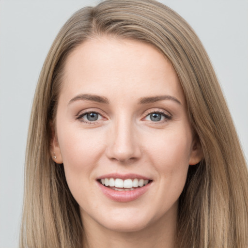 Joyful white young-adult female with long  brown hair and grey eyes