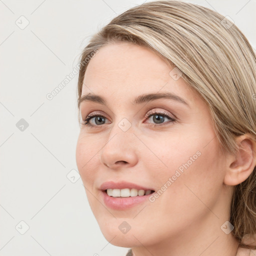 Joyful white young-adult female with long  brown hair and blue eyes