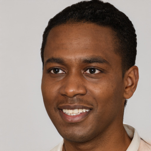 Joyful black young-adult male with short  black hair and brown eyes