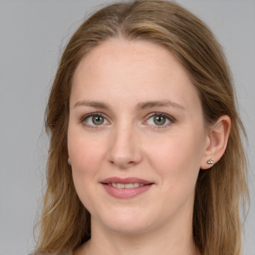 Joyful white young-adult female with long  brown hair and grey eyes