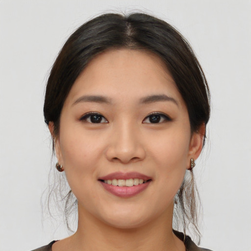 Joyful asian young-adult female with medium  brown hair and brown eyes