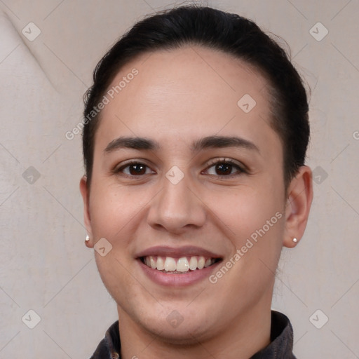 Joyful white young-adult female with short  brown hair and brown eyes