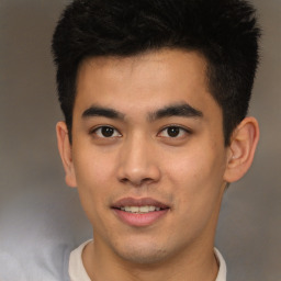 Joyful asian young-adult male with short  brown hair and brown eyes